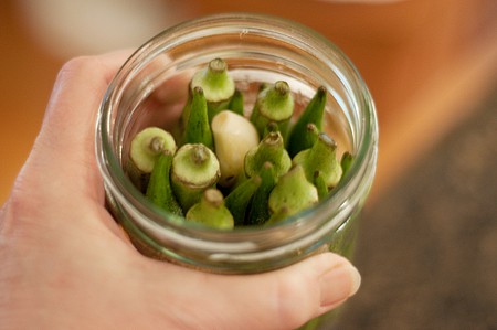 Packing jars of pickled okra
