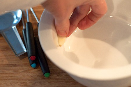 Rub the fondue pot with garlic
