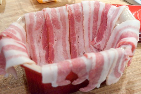 Line the terrine with bacon