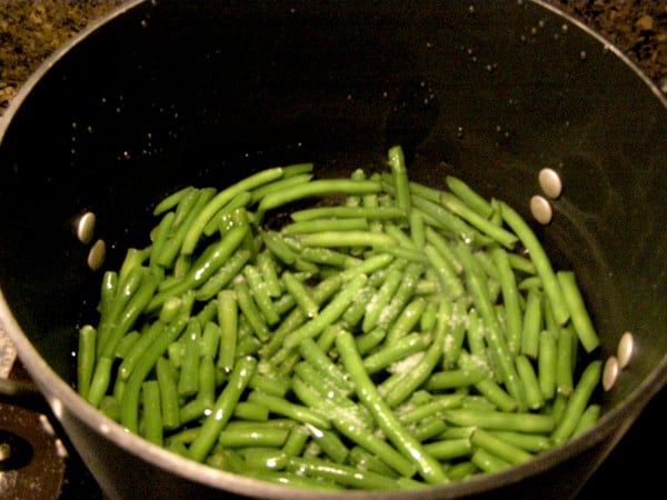 Green beans cooking in a large pot.
