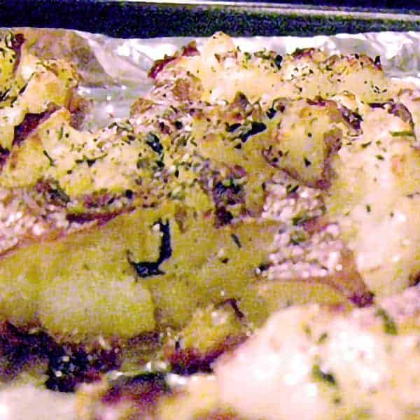 Crash Hot Potatoes are boiled until tender then crushed, brushed with olive oil and herbs, and baked until golden brown and crunchy! https://www.lanascooking.com/crash-hot-potatoes/