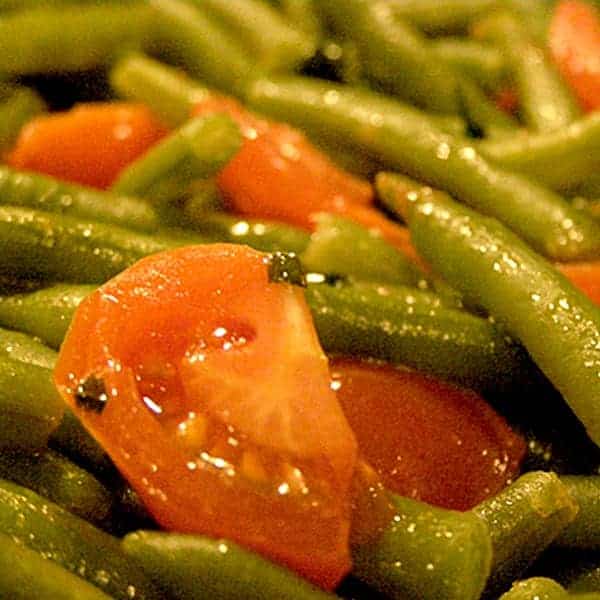 Green Beans with Cherry Tomatoes - A quick side dish perfect for roasted or fried chicken, pork, or even beef. Make it in minutes! https://www.lanascooking.com/green-beans-with-cherry-tomatoes/