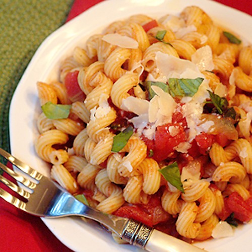 A serving of pasta arrabiata on a white plate.