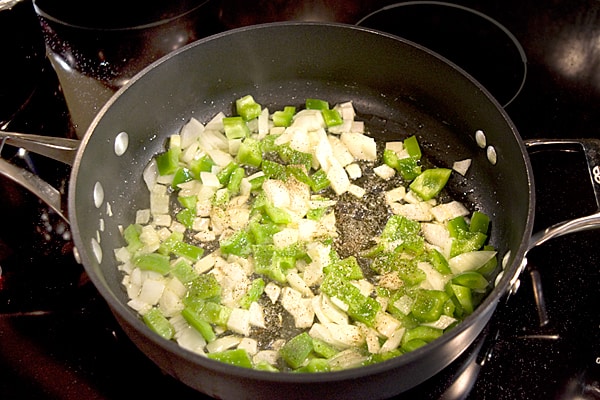 Vegetables cooking in a skillet.