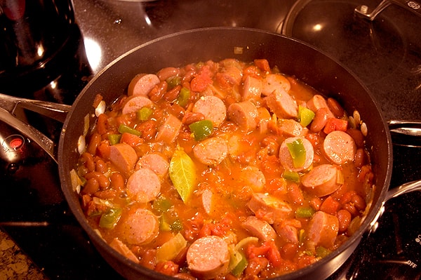 Beans and sausage added to skillet.