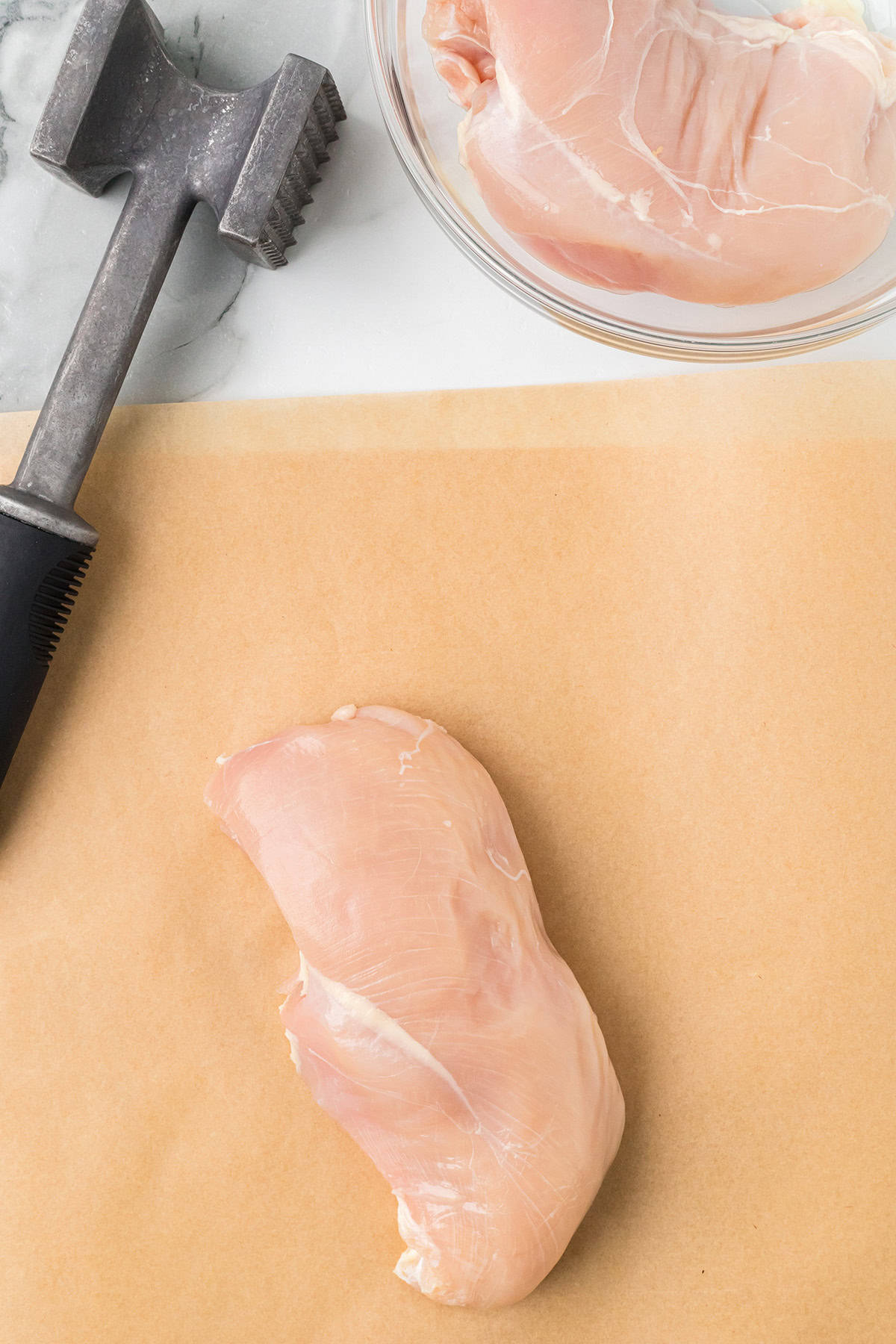 Preparing to flatten chicken breasts.