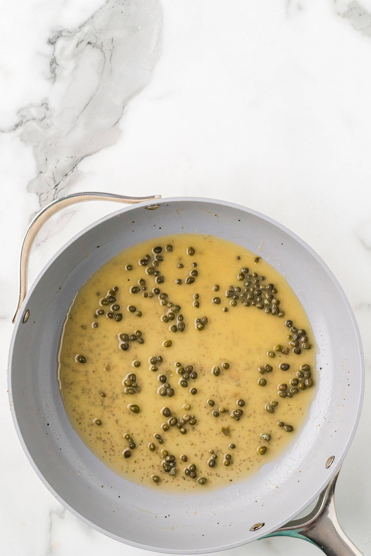 Capers added to sauce.