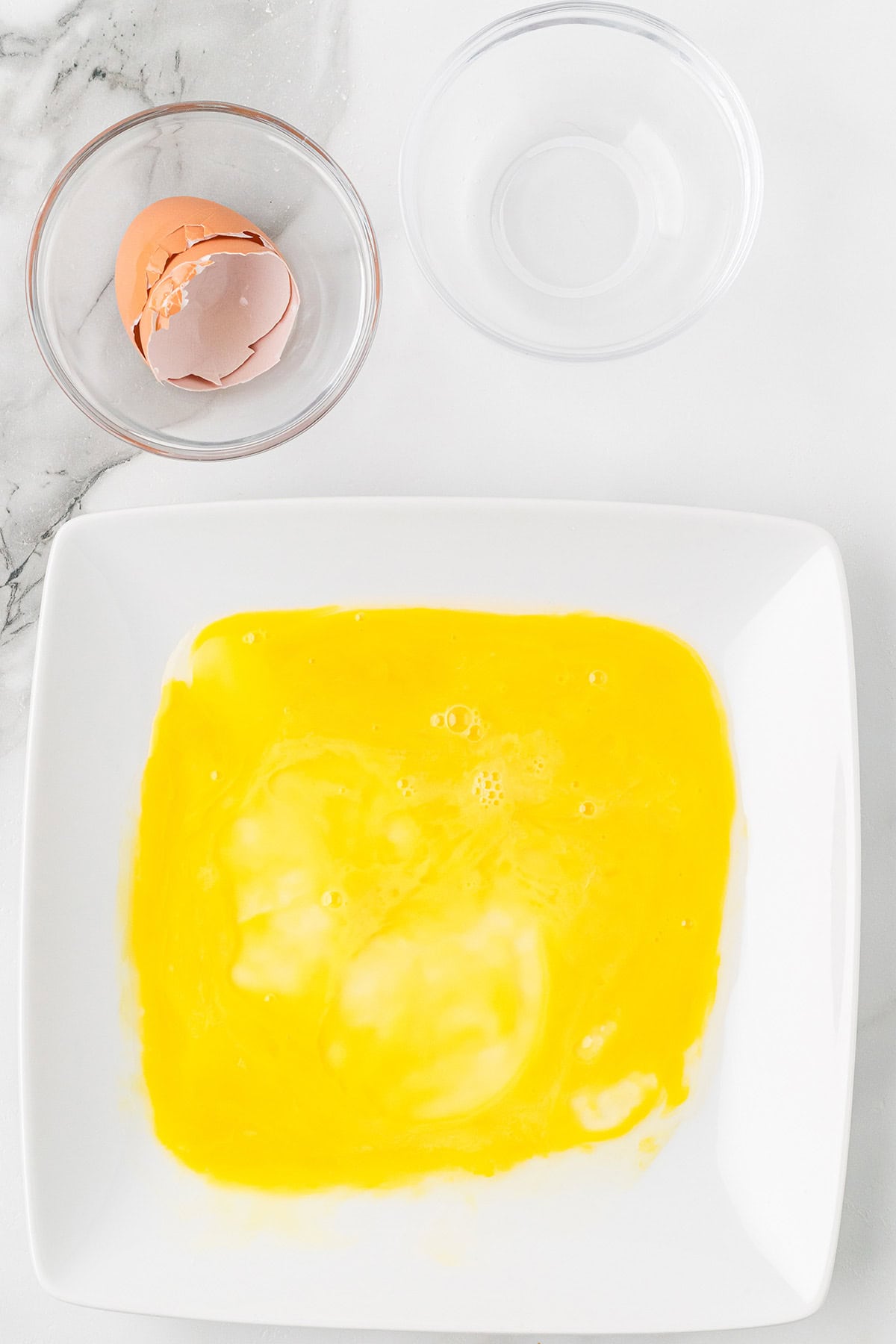 Beaten egg on a plate.