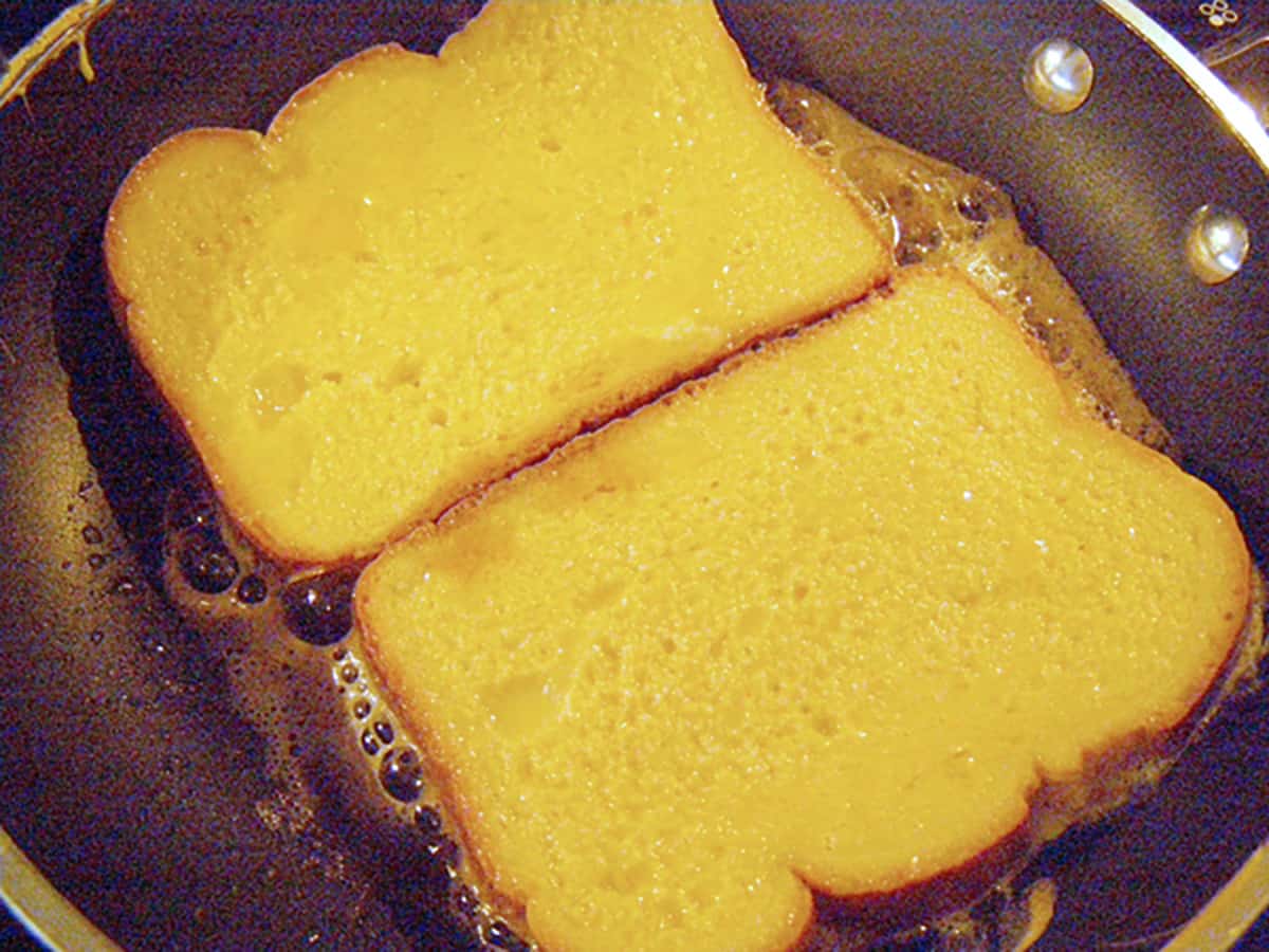 French toast cooking on the first side.