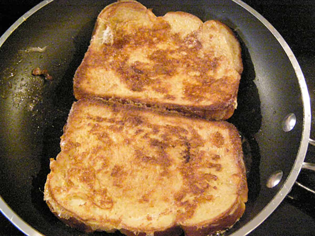 French toast cooking on the second side.