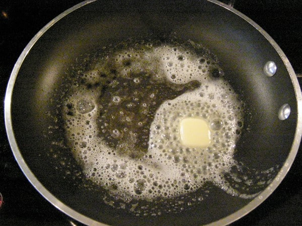 Butter melting in a nonstick skillet.