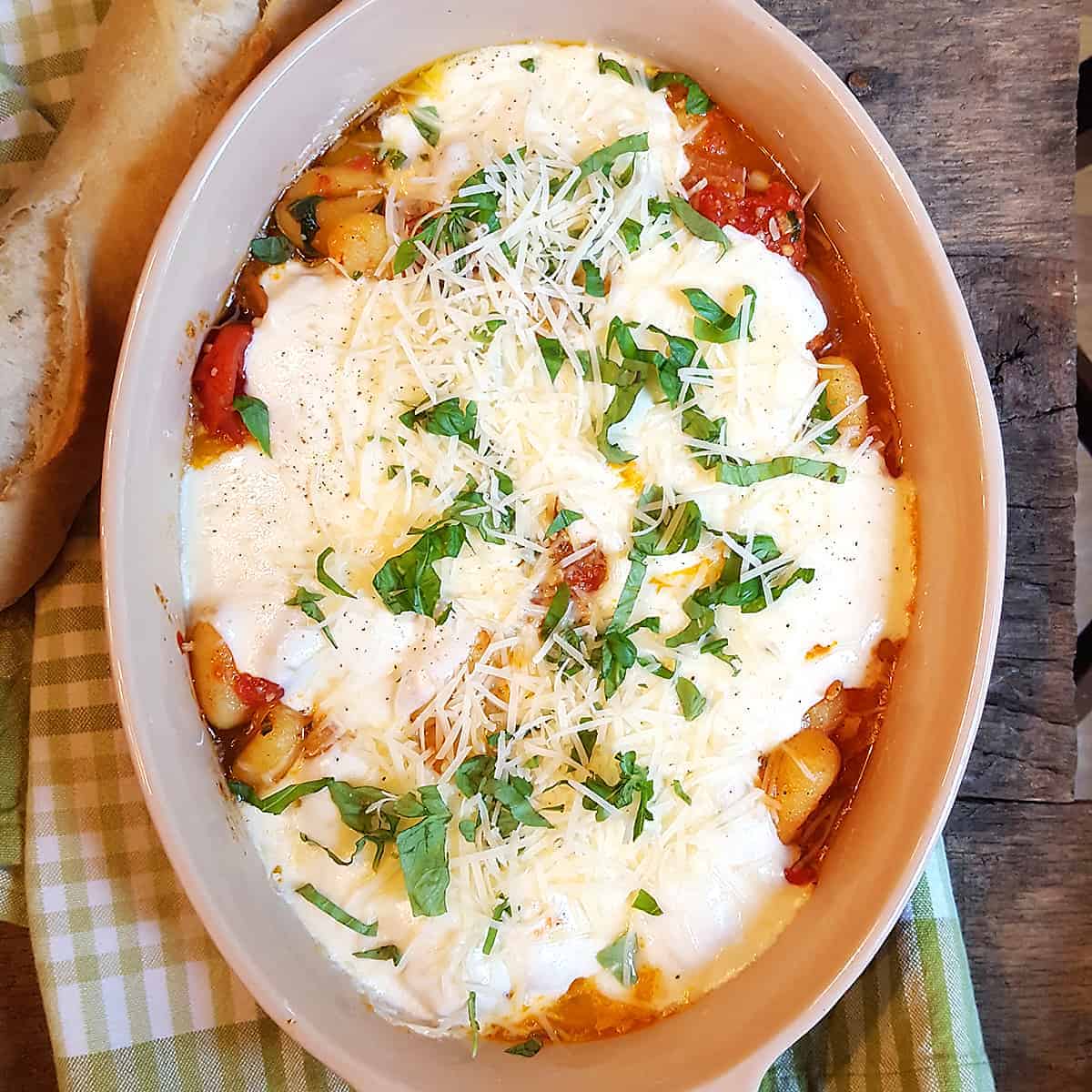 Gnocchi with Tomato Sauce - soft, pillowy gnocchi in a rich tomato sauce, topped with gooey mozzarella cheese. Kids love it! https://www.lanascooking.com/gnocchi-with-tomato-sauce/
