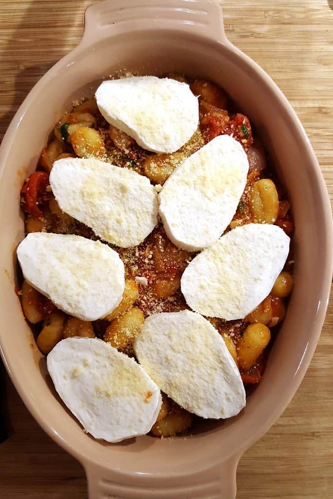 Gnocchi and tomato sauce topped with mozzarella and Parmesan cheeses