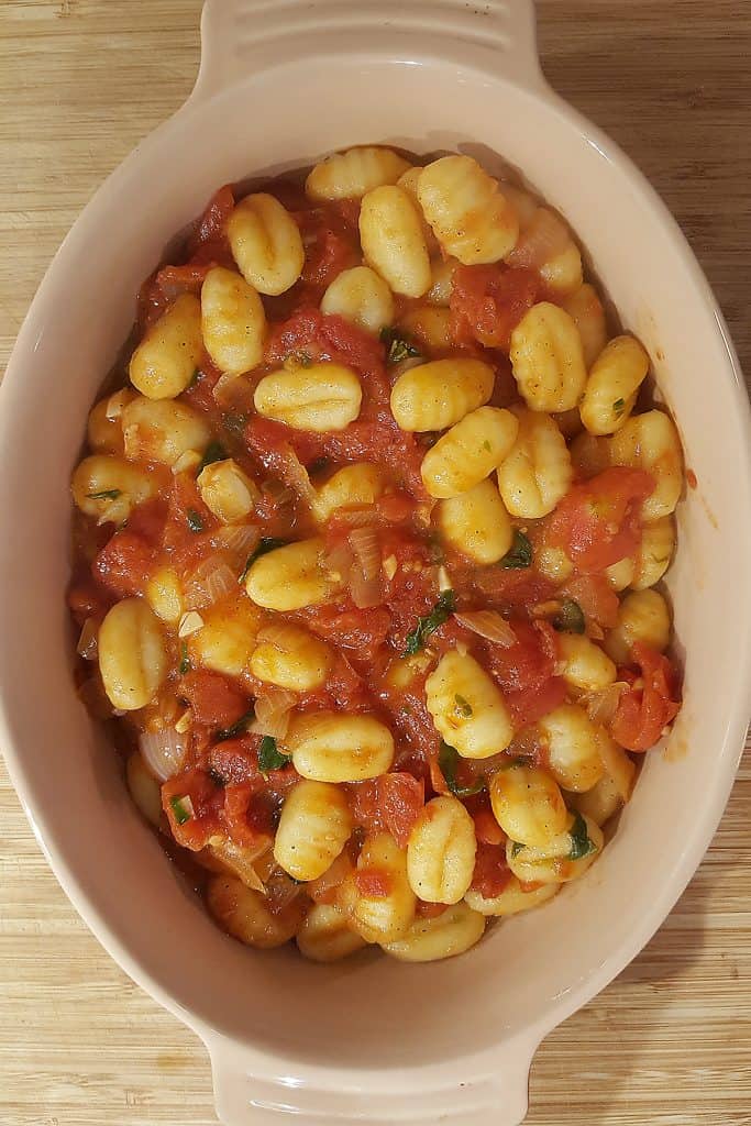 Gnocchi and tomato sauce in baking dish