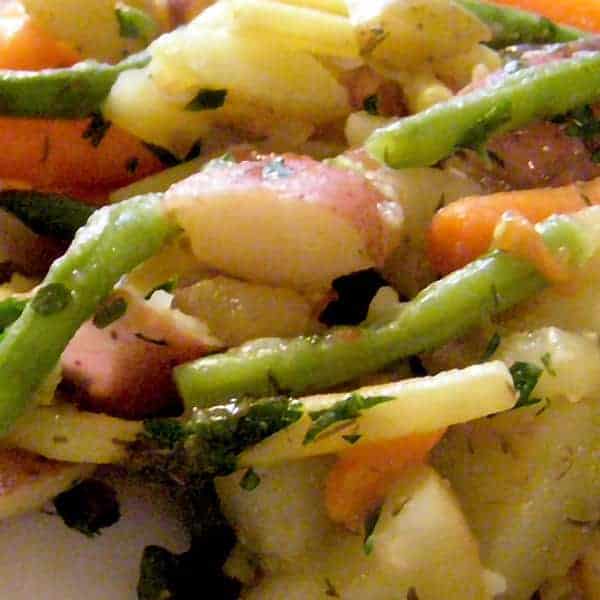 Potato and Green Bean Salad - A lovely, light, and fresh combination of potatoes, beans, carrots, and roasted tomatoes. Great for weeknight dinners. https://www.lanascooking.com/potato-and-green-bean-salad/