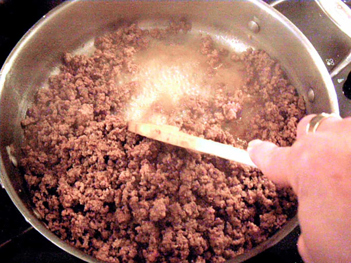 Ground beef browning in a skillet.