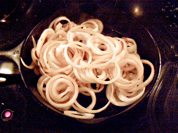 Cooking onions in a cast iron skillet.