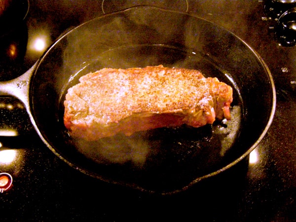 Cooking the steak on the second side.