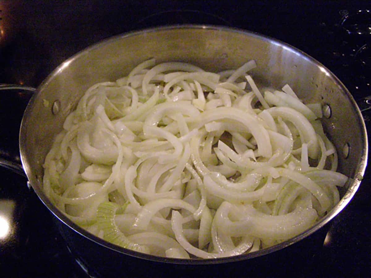 Onions cooking in a skillet.