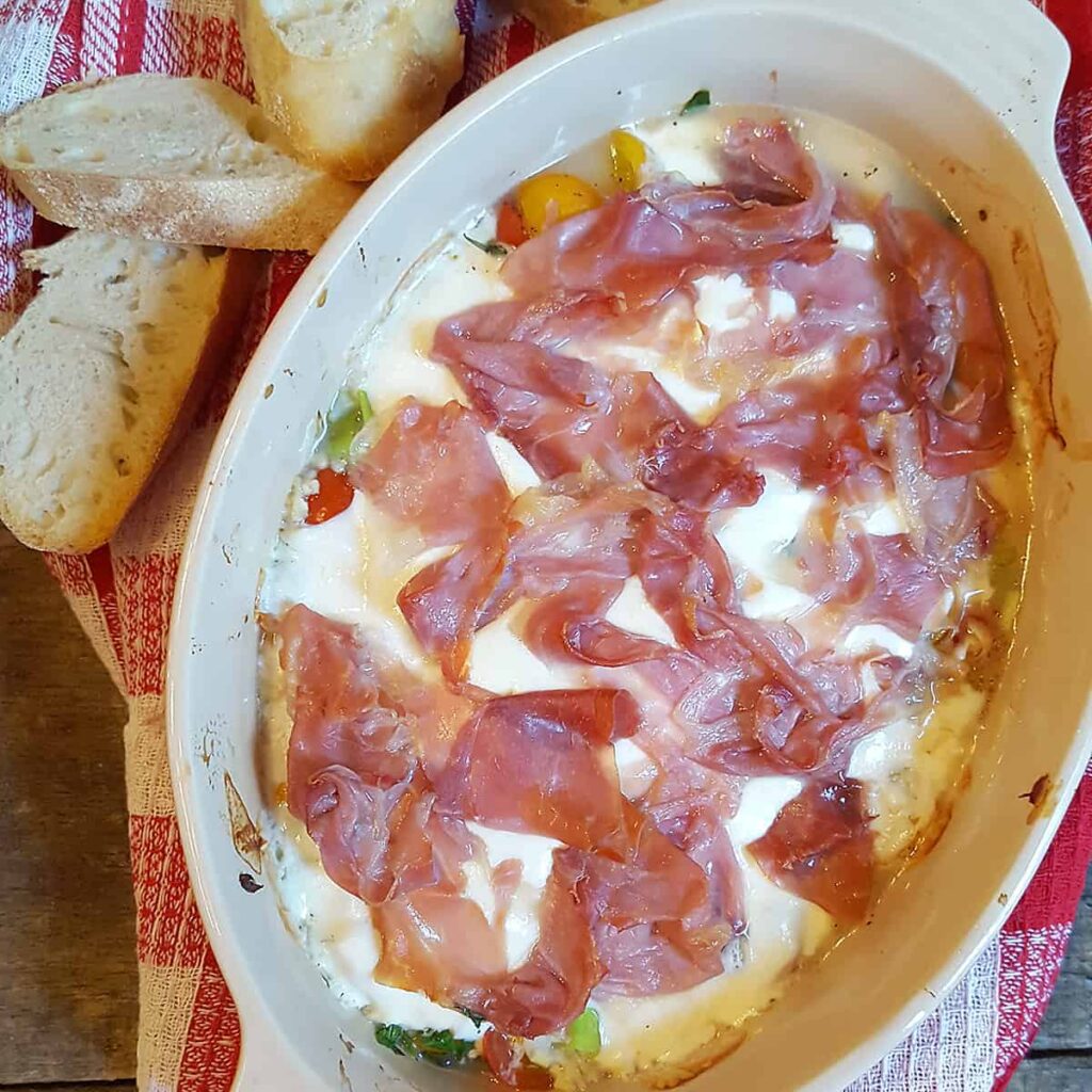 Baked Mozzarella with Prosciutto and Cherry Tomatoes - cherry tomatoes, basil, mozzarella, and prosciutto baked until bubbly. https://www.lanascooking.com/baked-mozzarella-and-cherry-tomatoes/