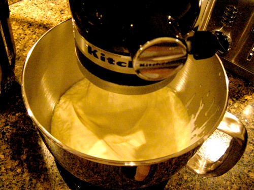 Cream being whipped in a stand mixer.