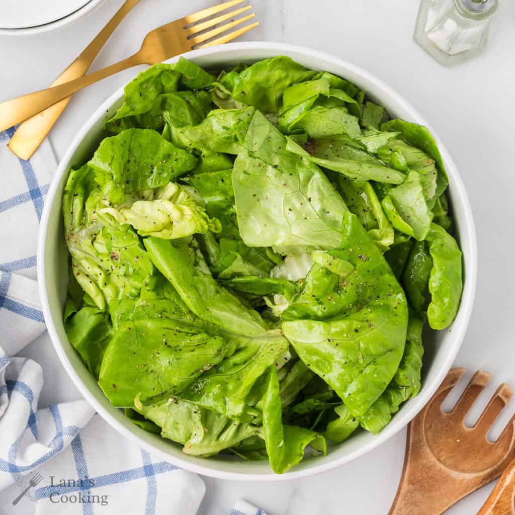 Finished salad in a white bowl.