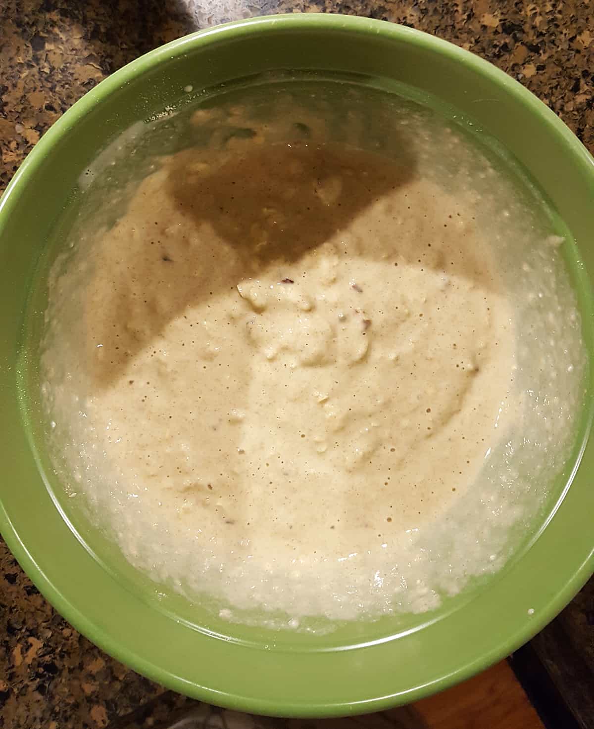 Medium bowl containing mixed batter for pancakes.