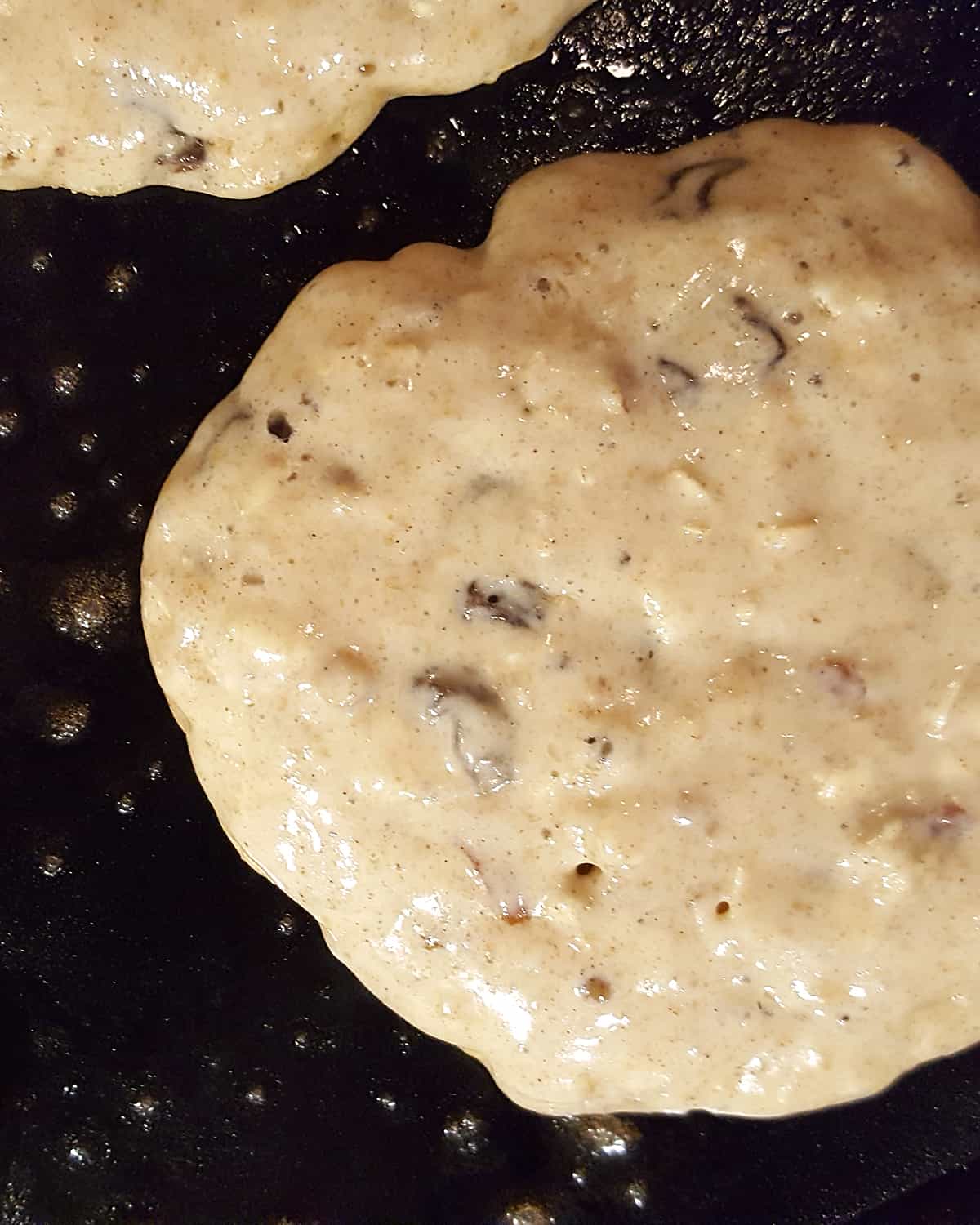 Closeup view of pancake cooking illustrating how bubbles appear on the surface.