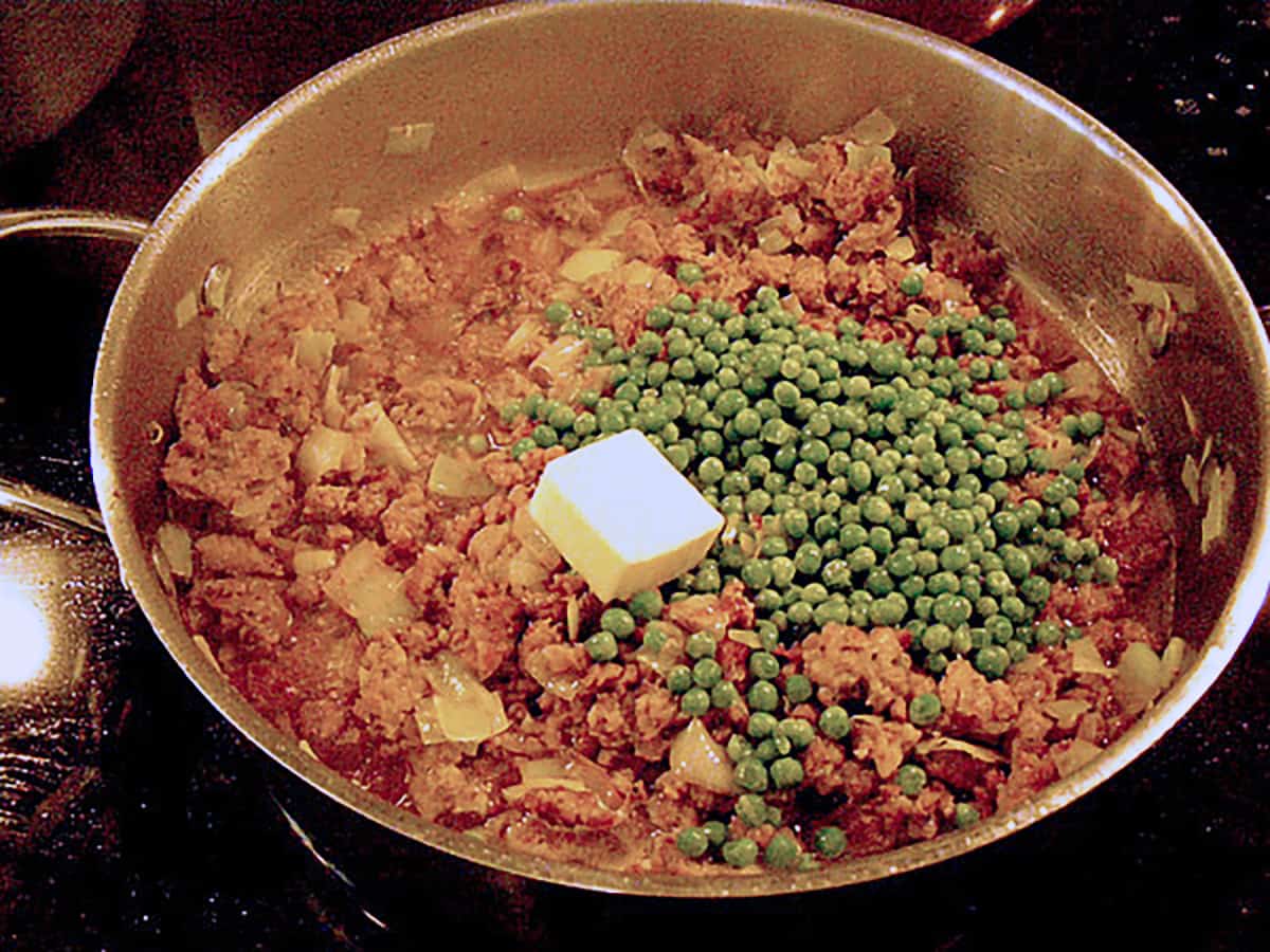 Butter and peas added to the sauce.