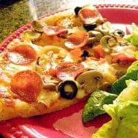 Favorite Homemade Pizza - easy to make homemade pizza dough with our favorite pepperoni and mozzarella cheese toppings. https://www.lanascooking.com/favorite-homemade-pizza/
