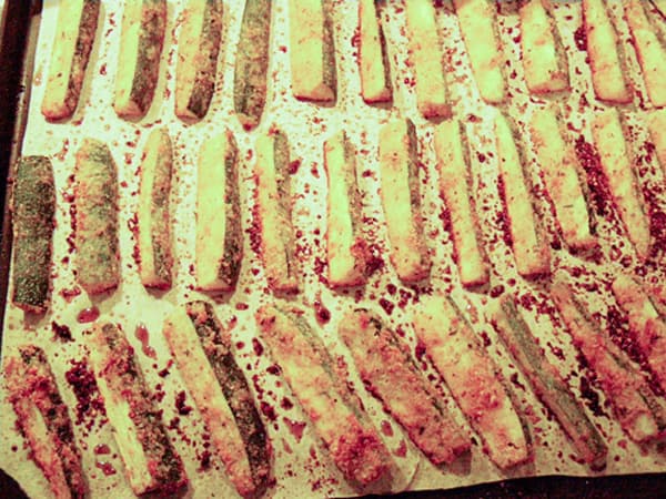Finished zucchini fries on a baking sheet.