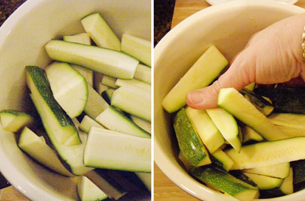 Coating the zucchini sticks with the egg wash.