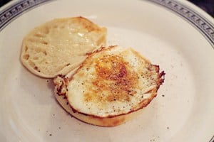 A fried egg added on top of English muffin.