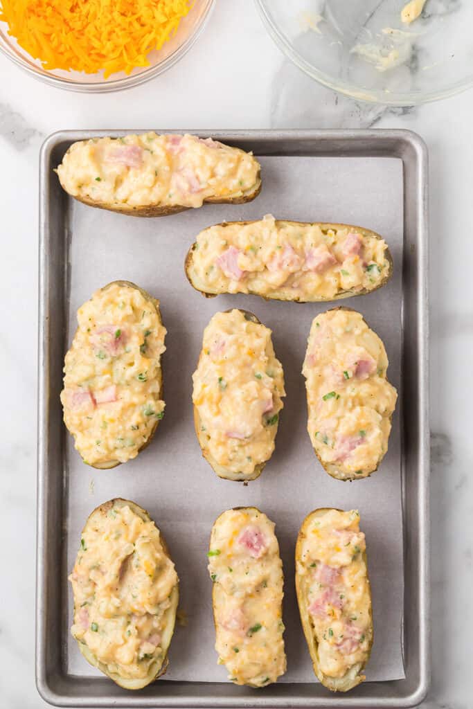 Potato halves filled with ham and cheese mixture.