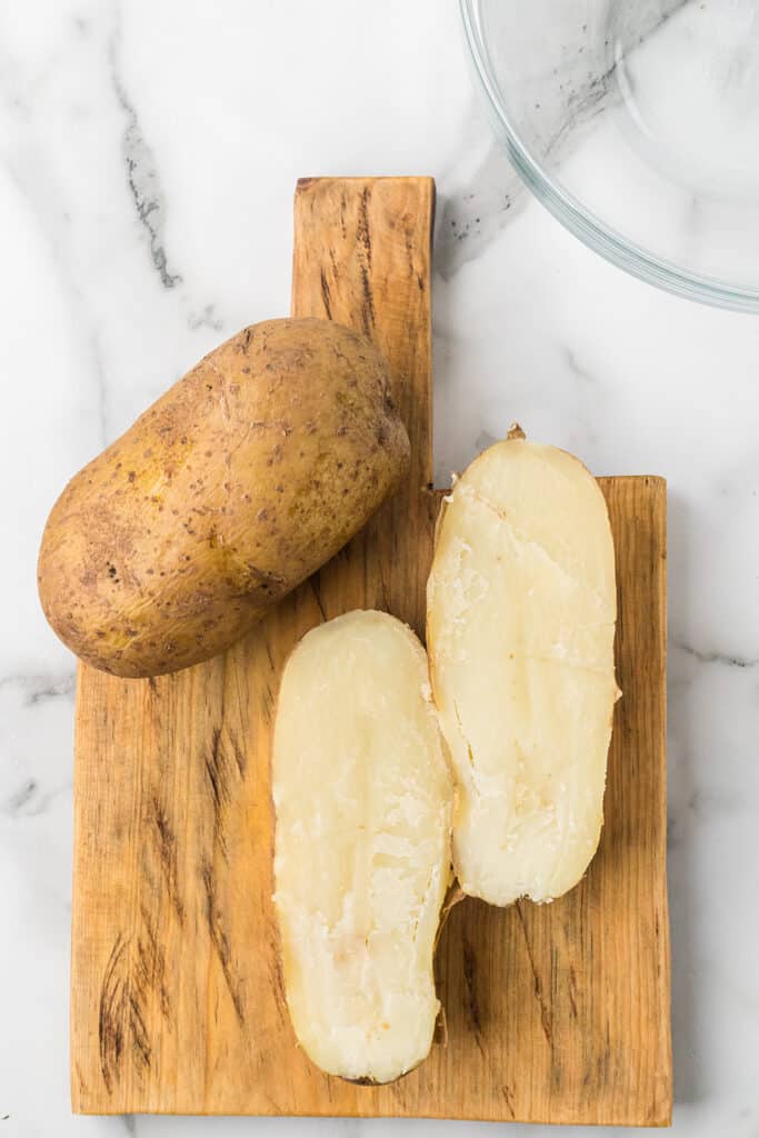 Cooked potatoes cut in half.