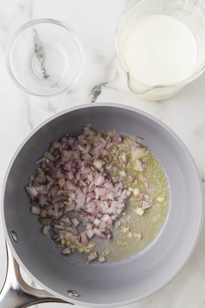 Minced shallot added to melted butter.