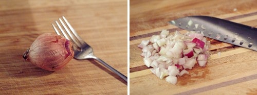 Diced shallot and knife on a board.