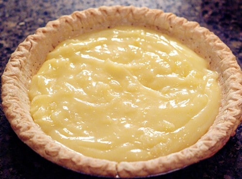 Lemon pie filling added to baked pie shell.