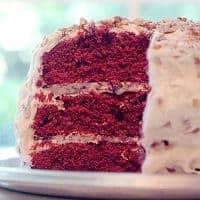 This classic Red Velvet Cake features chocolate layers colored red and slathered with loads of cream cheese frosting studded with pecans. https://www.lanascooking.com/red-velvet-cake/