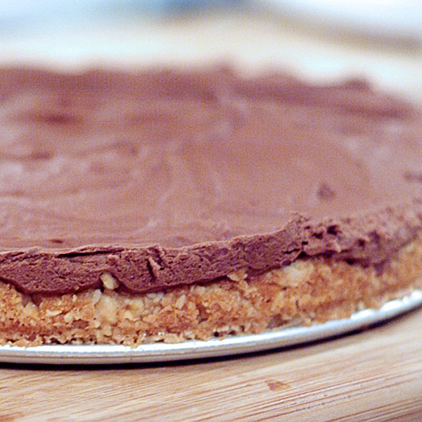 Finished chocolate cheesecake with springform pan sides removed.