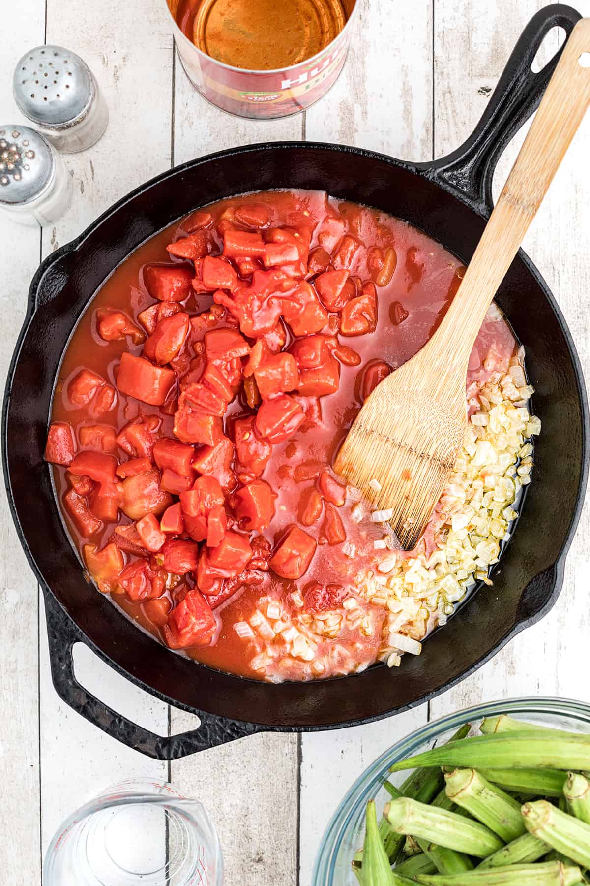 Diced tomatoes added to skillet.