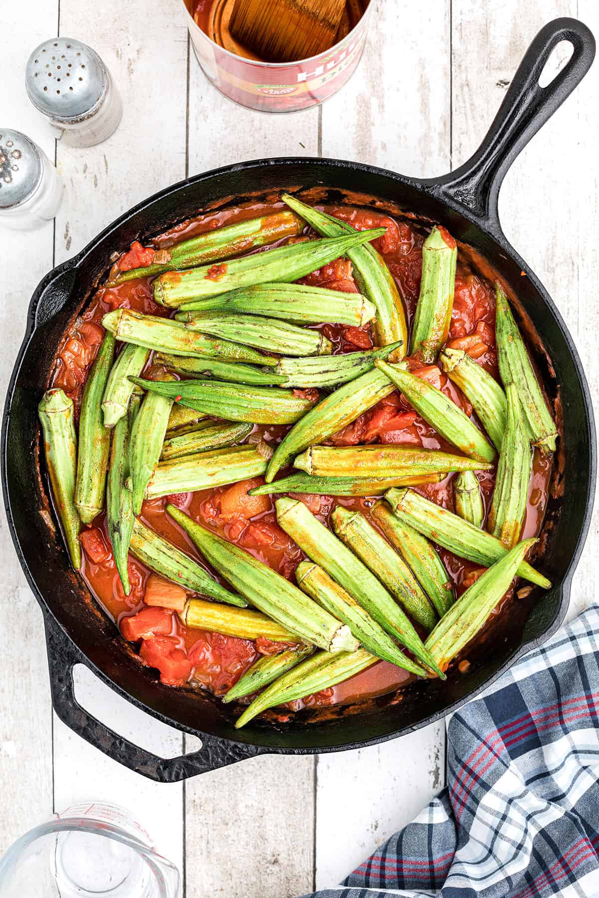 Okra added to tomatoes and onions in the skillet.