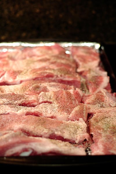 Pork ribs on a baking sheet.