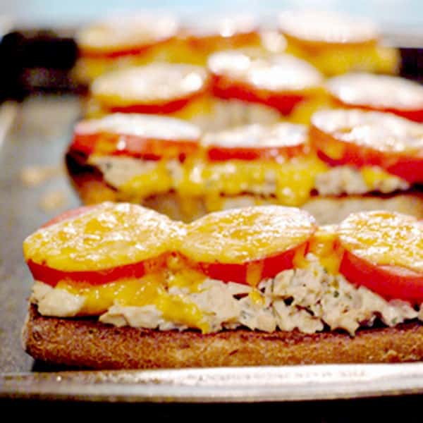Classic tuna melt - a kicked-up tuna sandwich on toasted ciabatta bread with tomatoes and cheddar cheese! https://www.lanascooking.com/tuna-melt/