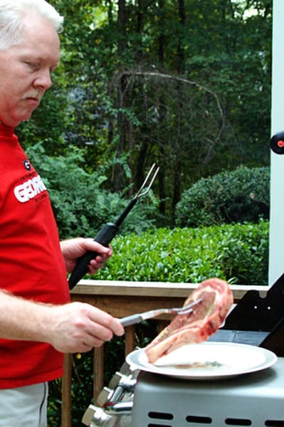 A man standing at a grill.
