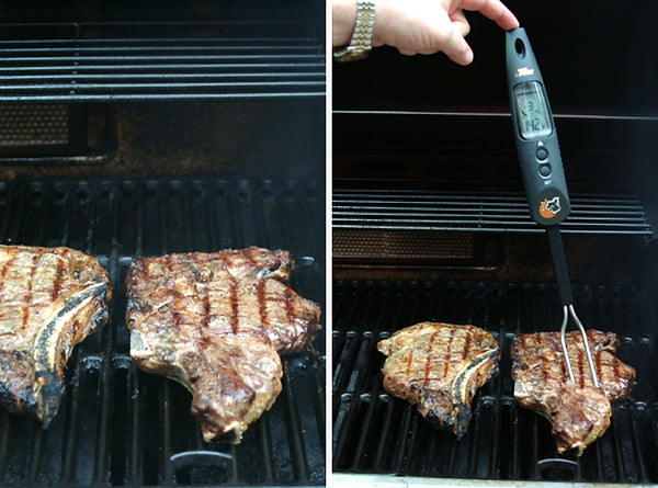 Checking the temperature of steaks cooking on a grill.