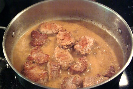 Meat added back to the sauce in the pan.