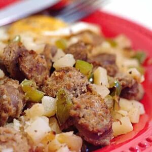 Sausage Potato Hash is loaded with smoked sausage, hash browns, and peppers for a fantastic breakfast treat! https://www.lanascooking.com/sausage-potato-hash-and-100th-post-giveaway/