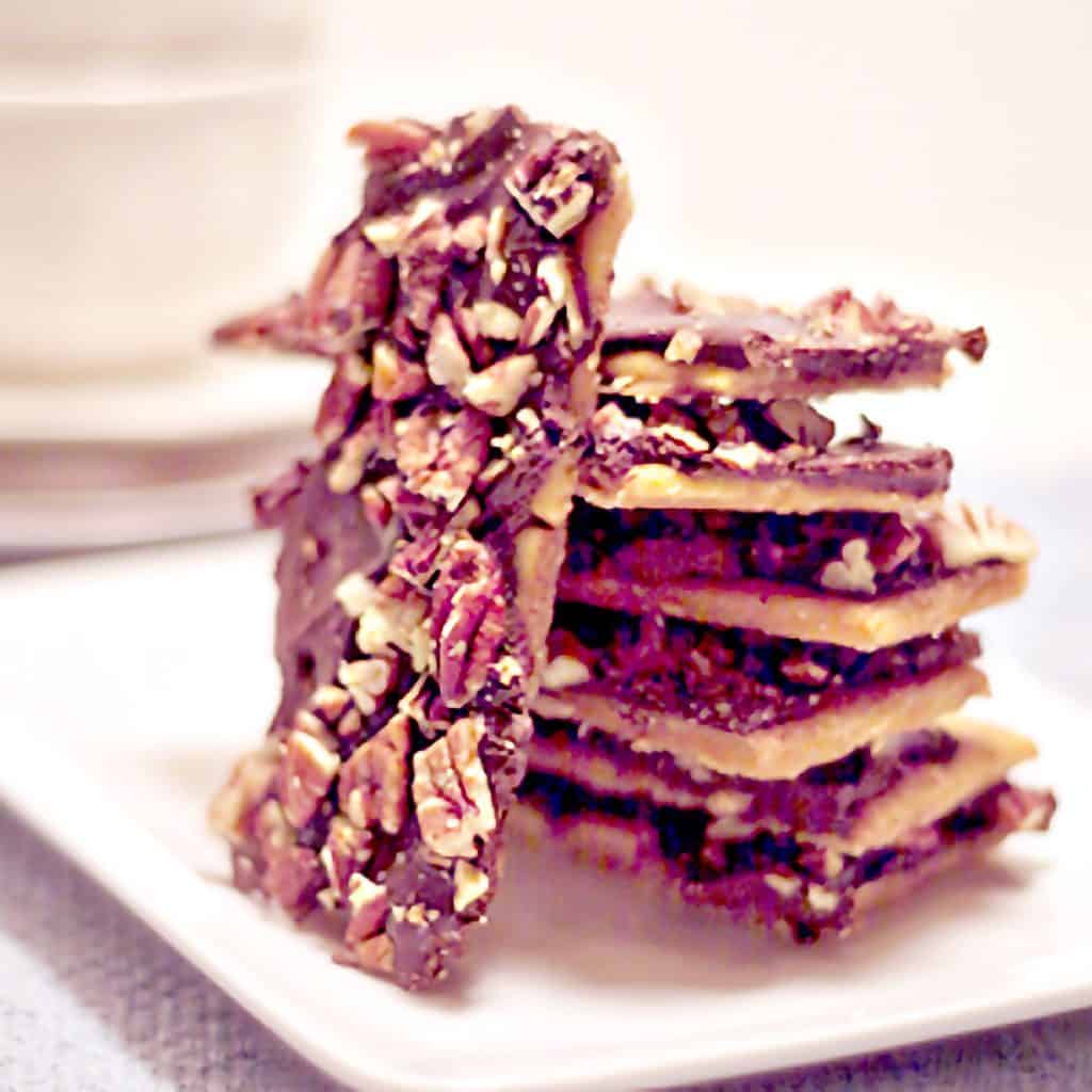A stack of pieces of Saltine Cracker Toffee on a serving plate.