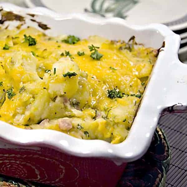 Cheesy Ham and Potato Bake is just good, old fashioned comfort food. Ham, cheese and potatoes combined in an oven-baked dish. https://www.lanascooking.com/cheesy-ham-and-potato-bake/